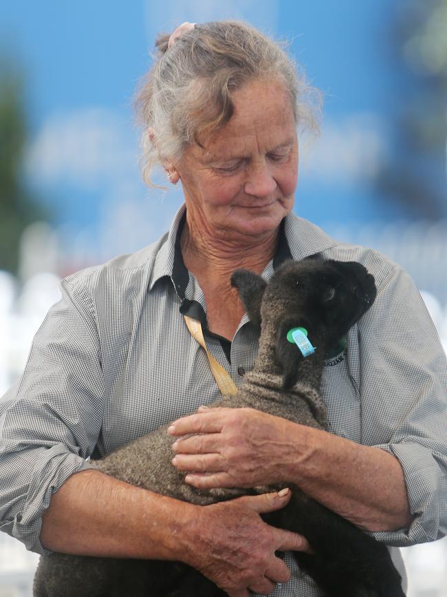 Helen Raven with her lamb she managed to rescue by feeding by hand. Picture: Yuri Kouzmin