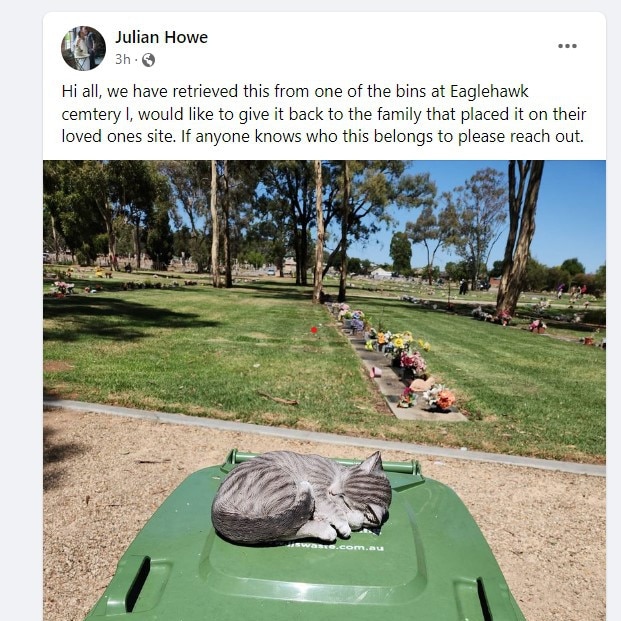 At the Eaglehawk cemetery. A statue of a cat was placed on a bin lid but rescued from the rubbish heap by a passer-by who has offered to return it to the mourner who left it for a loved one.