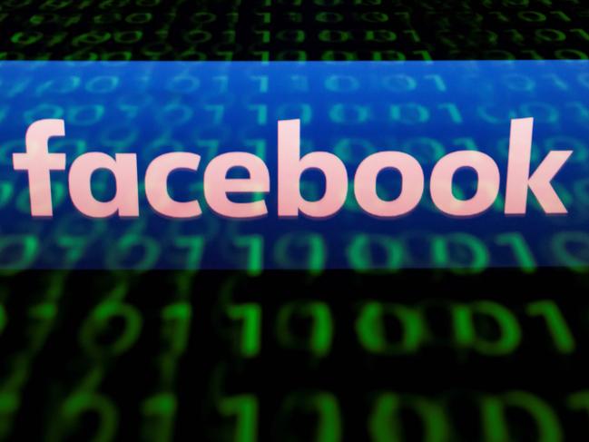 (FILES) In this file photo illustration picture taken on April 29, 2018,  the logo of social network Facebook is displayed on a screen and reflected on a tablet in Paris.  Thousands of Facebook and Instagram advertisements taken out by a Russian internet group were released May 10, 2018 in a database that illustrate how a concerted effort was made to foment anger and split US society around the 2016 election. Democrats of the House Intelligence Community released records of more than 3,000 ads from 2015-2017 that were allegedly placed by the Kremlin-linked Internet Research Agency, a Saint Petersburg operation that allegedly spreads disinformation and political propaganda across the internet and social media in Russia and in countries where Moscow wants to influence politics.  / AFP PHOTO / Lionel BONAVENTURE