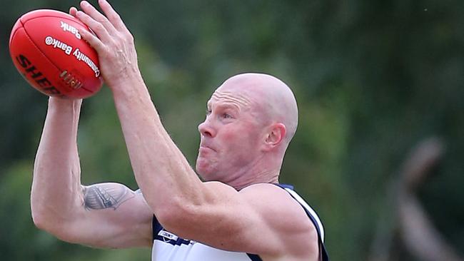 One of former AFL star Barry Hall’s strong grabs in his one-off appearance for Pearcedale. Picture Yuri Kouzmin