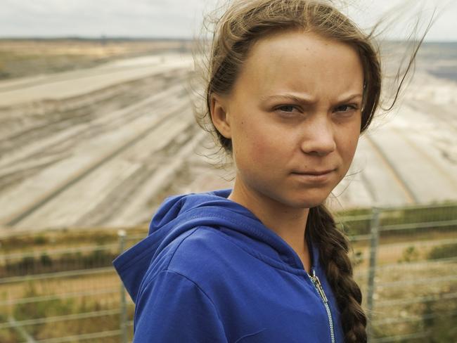 Climate activist Greta Thunberg stands in front of the open-cast lignite pit during a visit the ancient Hambach Forest near the city of Kerpen in western Germany, Saturday Aug. 10, 2019. The teenage activist who is a leading figure in the Fridays for Future strikes against climate said that seeing the open-cast lignite pit in Hambach disturbed her deeply and that the time has come to stop talking and take action. (AP Photos/Mstyslav Chernov)