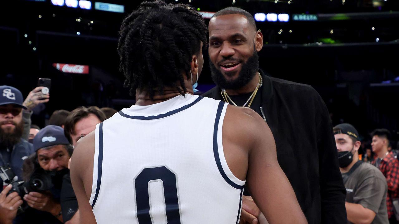 LOS ANGELES, CALIFORNIA - DECEMBER 04: LeBron James #6 of the Los Angeles Lakers talks with his son Bronny James #0 of Sierra Canyon after the game against St. Vincent - St. Mary during The Chosen-1's Invitational at Staples Center on December 04, 2021 in Los Angeles, California. Harry How/Getty Images/AFP == FOR NEWSPAPERS, INTERNET, TELCOS &amp; TELEVISION USE ONLY ==