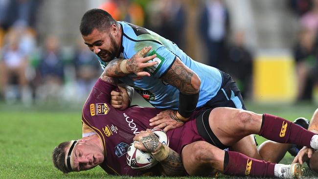 Andrew Fifita of the NSW Blues (top) tackles Josh McGuire of the Queensland Maroons during Game one of the State of Origin series at Suncorp Stadium in Brisbane, Wednesday, May 31, 2017. (AAP Image/Dan Peled) NO ARCHIVING, EDITORIAL USE ONLY