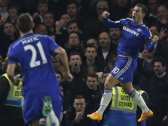 Chelsea's Eden Hazard, right, leaps and punches the air as he celebrates after scoring the opening goal.