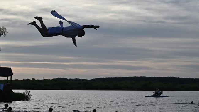 People cooling off after volunteering to clear destroyed building in villages Shestovytsya and Yagidne, Chernigiv region. Picture: AFP