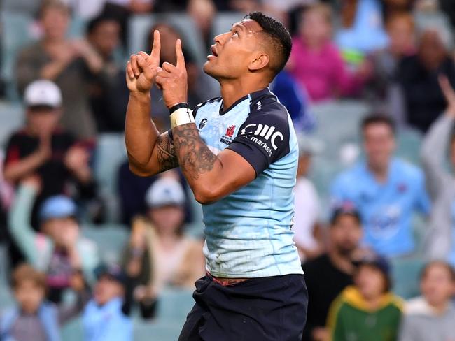 Israel Folau celebrates scoring against the Rebels.