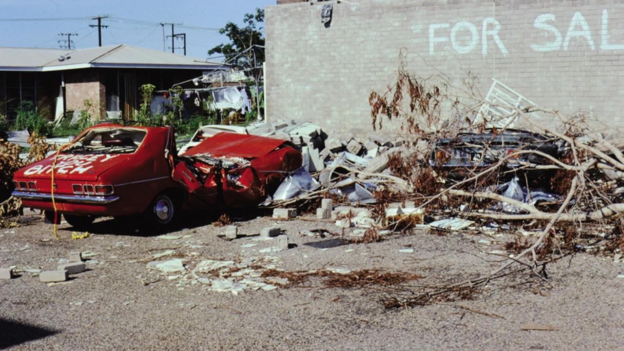 John Garner's crushed Holden Torana, emblazoned with the phrase 'Tracey [sic] You Bitch' became one of the defining images of Cyclone Tracy and its aftermath. Picture: Supplied