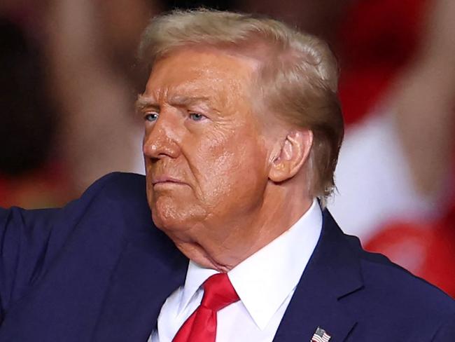 TOPSHOT - Former US President and Republican presidential candidate Donald Trump gestures at the end of a campaign rally at PPG Paints Arena in Pittsburgh, Pennsylvania on November 4, 2024. (Photo by CHARLY TRIBALLEAU / AFP)