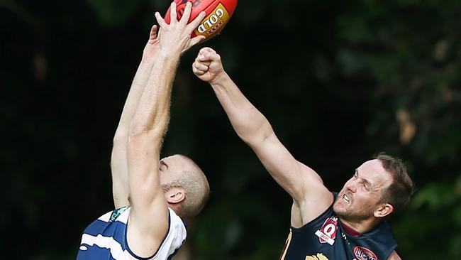 Brad Wallace punches the ball from Adam Gross' hands as he takes a mark. PICTURE: BRENDAN RADKE.