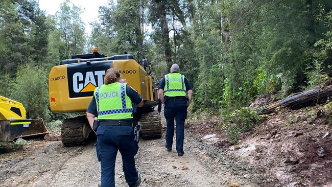 Police on the scene after Ailsa Bennell, a Bob Brown Foundation protester who chained herself to an excavator. Ms Bennell had her charges dropped.