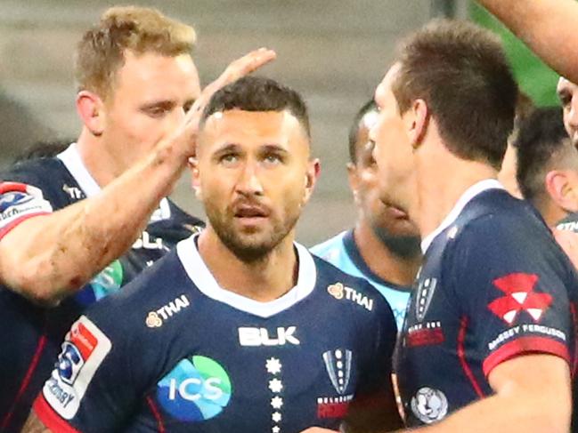 MELBOURNE, AUSTRALIA - MAY 31: Quade Cooper of the Rebels is congratulated by his teammates after scoring a try during the round 16 Super Rugby match between the Rebels and the Waratahs at AAMI Park on May 31, 2019 in Melbourne, Australia. (Photo by Scott Barbour/Getty Images)