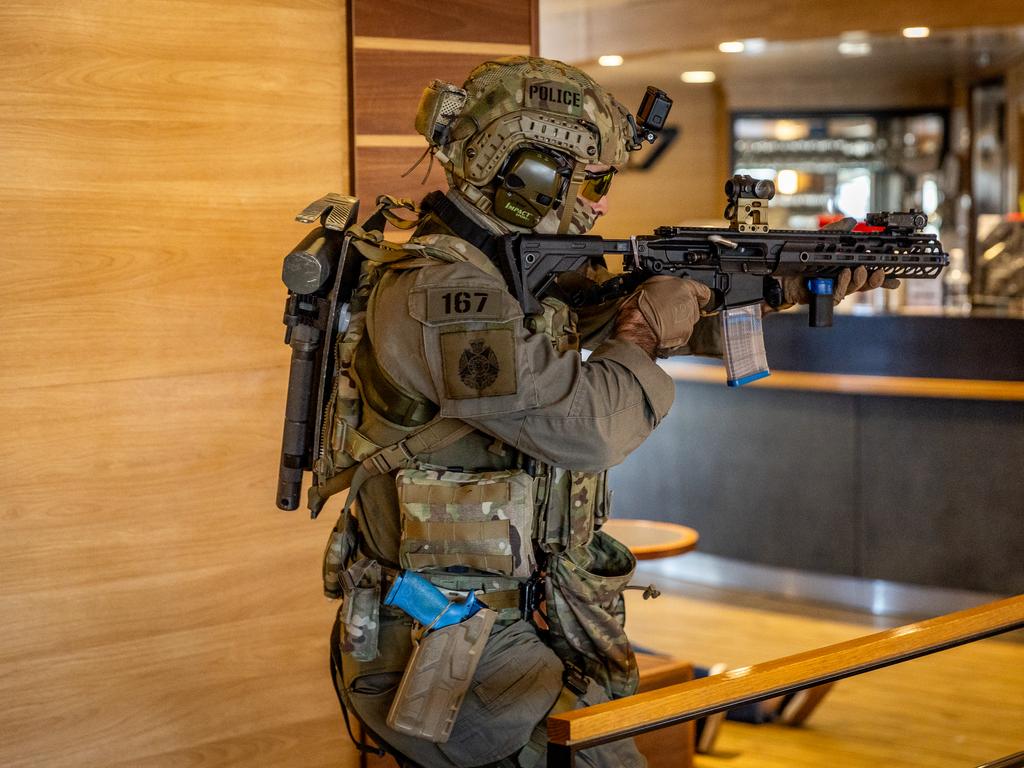 An officer fires his weapon while engaging a perpetrator. Picture: Jake Nowakowski