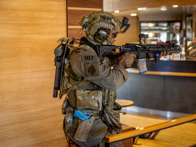 An officer fires his weapon while engaging a perpetrator. Picture: Jake Nowakowski