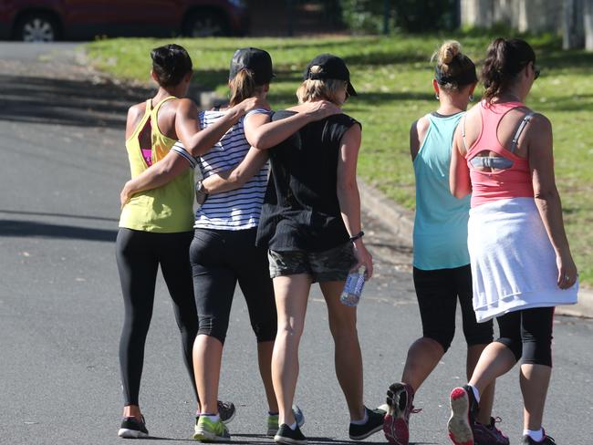 Friends arriving to lay flowers near the home of Tina Kontozis.