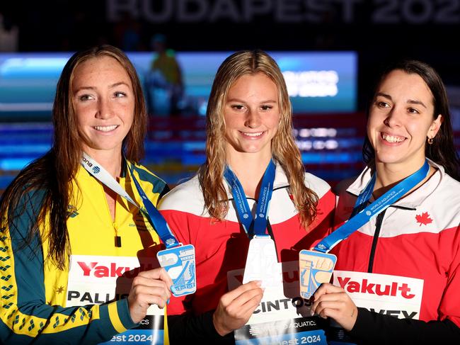 BUDAPEST, HUNGARY - DECEMBER 10: Gold medalist Summer McIntosh of Canada, silver medalist Lani Pallister of Australia and bronze medalist Mary-Sophie Harvey of Canada pose with their medals after the Women's 400m Freestyle Final during day one of the World Aquatics Swimming Championships (25m) 2024 at Duna Arena on December 10, 2024 in Budapest, Hungary. (Photo by Dean Mouhtaropoulos/Getty Images)