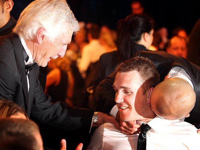 Brownlow Medal winner Dane Swan is congratulated by coach Mick Malthouse (along with Sydney's Rhyce Shaw). Picture: Michael Klein