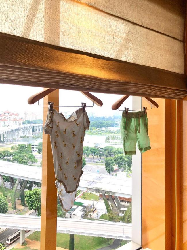 Joy Van Dee dried her child’s clothes in their hotel room while waiting out quarantine in Singapore.