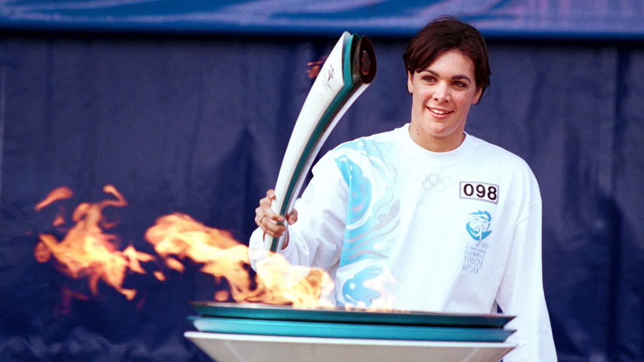Aust swimmer Samantha (Sam) Riley holding the Olympic flame after lighting cauldron at the end of her torch relay run in Brisbane 13 Jun 2000.