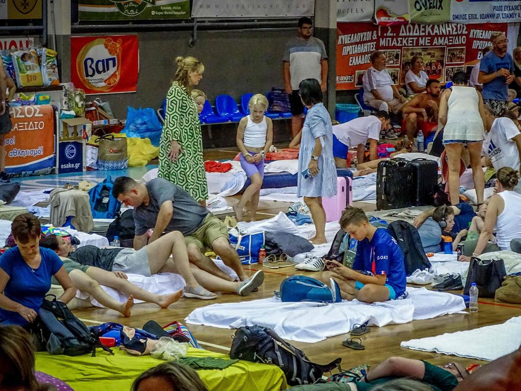 Tourists gather in a basketball hall. Picture: AFP