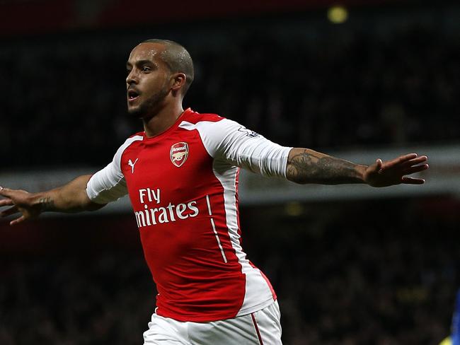 Arsenal's English midfielder Theo Walcott (C) celebrates scoring their second goal during the English Premier League football match between Arsenal and and Leicester City at the Emirates Stadium in London on February 10, 2015. AFP PHOTO / ADRIAN DENNIS RESTRICTED TO EDITORIAL USE. No use with unauthorized audio, video, data, fixture lists, club/league logos or "live" services. Online in-match use limited to 45 images, no video emulation. No use in betting, games or single club/league/player publications.