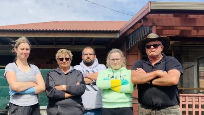 Hope Green, Lynette Green, Adin Oates, Ella MacIntosh and Frank Green outside their rental property left allegedly trashed by previous tenants.