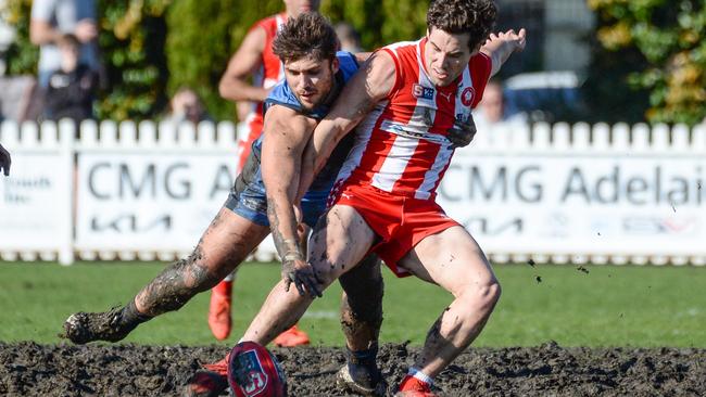 Sturt’s James Battersby fights for position with North’s Harrison Elbrow at a muddy Unley Oval. Picture: Brenton Edwards