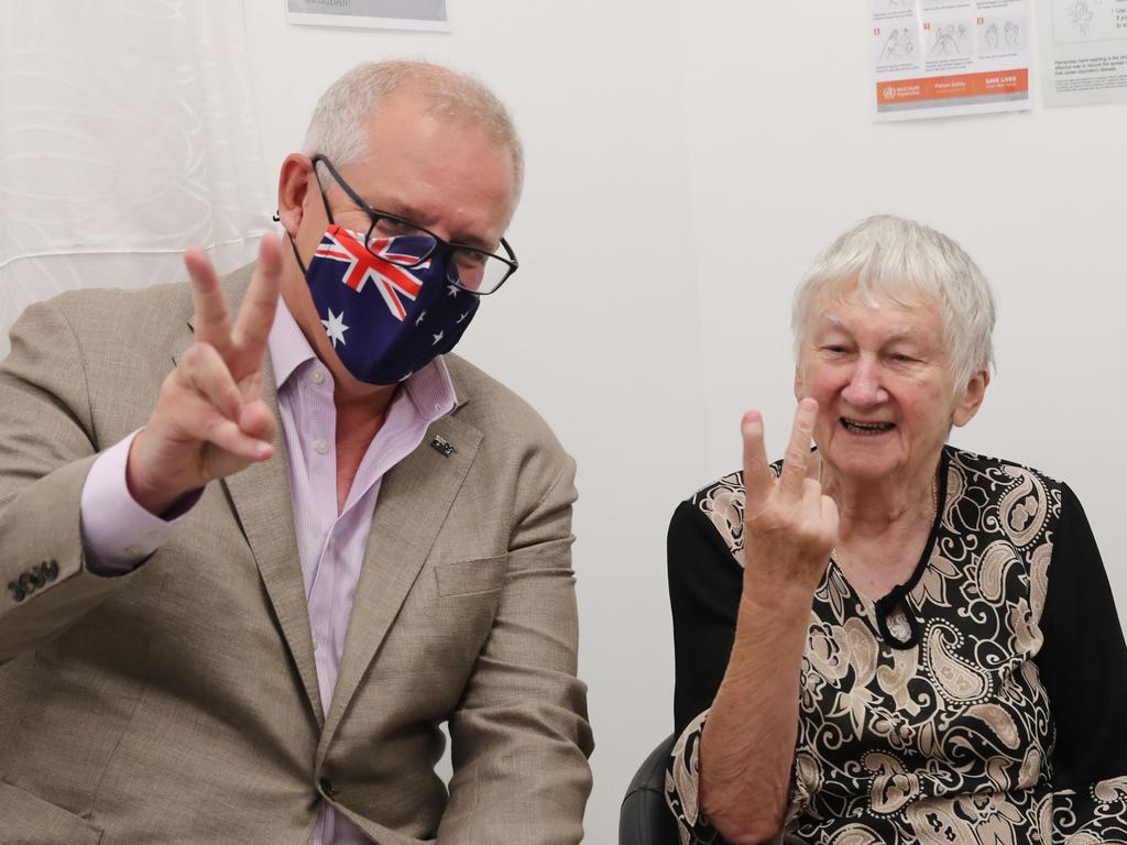 Jane Malysiak accidentally flashes an obscene gesture after receiving the COVID-19 vaccine. Picture: Adam Taylor/PMO