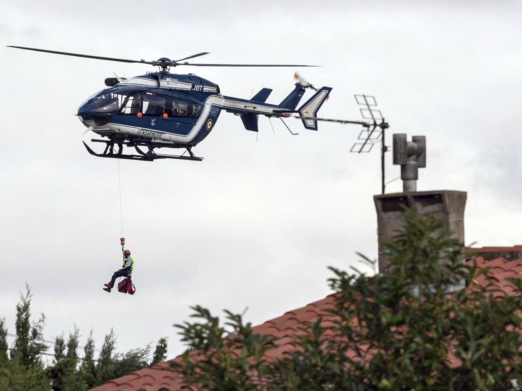 A French Gendarmerie helicopter winches a rescue worker over the town of Trebes, southern France. Picture: AP