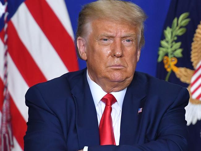 US President Donald Trump listens to officials during a roundtable discussion on community safety, at Mary D. Bradford High School in in Kenosha, Wisconsin on September 1, 2020. - Trump said Tuesday on a visit to protest-hit Kenosha, Wisconsin that recent anti-police demonstrations in the city were acts of "domestic terror" committed by violent mobs. "These are not acts of peaceful protest but really domestic terror," Trump said, describing multiple nights of angry demonstrations last week after a white police officer in Kenosha shot a black man in the back at close range. (Photo by MANDEL NGAN / AFP)