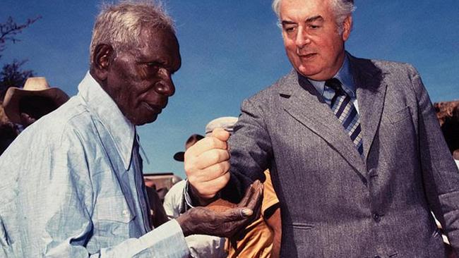 Gough Whitlam pouring soil into the hands of Vincent Lingiari in 1975. PICTURE: Merv Bishop
