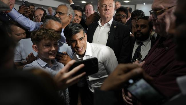 Prime Minister Rishi Sunak poses for a selfie with supporters at a Tory party rally in Amersham, England. Picture: Getty Images.