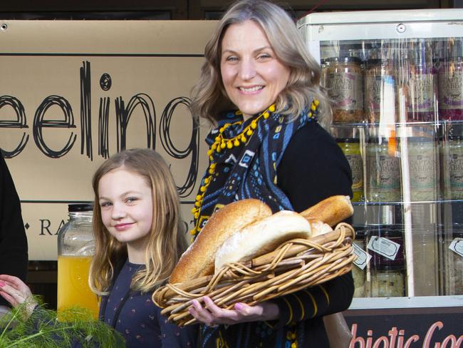 ADELAIDE, AUSTRALIA - Advertiser Photos AUGUST 14, 2021: *WARNING* Embargoed for Tuesday's paper: Willunga Farmers Market regulars Amanda Fleming (042009426) from Willunga and Becky Hirst with 9yr old daughter Elsie Procter from Blewitt Springs (0449190125) buying goods from Yasmin Whitehead (0404216683) at her stall Gut Feeling. Willunga Farmers Market has been named the best farmers market in Australia at the delicious. Harvey Norman Produce Awards. Picture: Emma Brasier