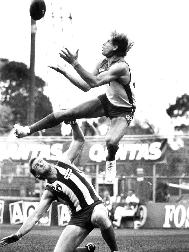 Capper uses Mick Martyn as a stepladder to take this mark for the Swans against North Melbourne. Picture: News Corp