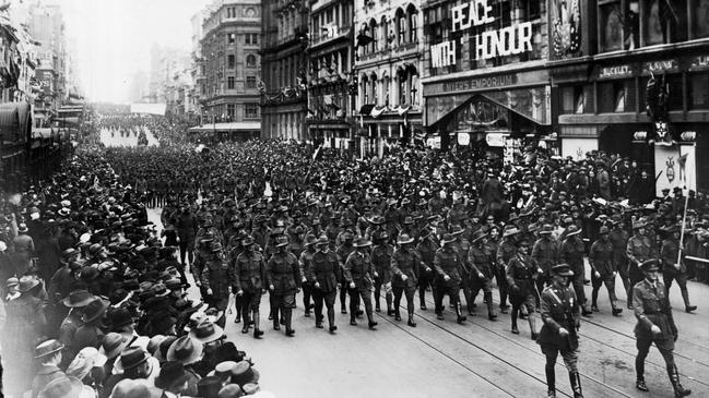 Troops parade down Bourke St, past Myer's Emporium, in a 1918 victory march on their way to Parliament House.