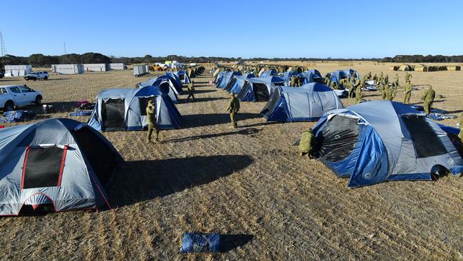 Soldiers set up camp on Kingscote Airport. The Defence Force has sent 100 reservists and also a water purifier which should arrive tonight. Picture: AAP / David Mariuz