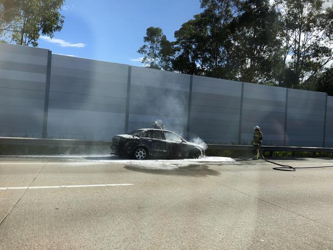 A car on fire on the M1 near Exit 49 on the Gold Coast. Photo: Amanda Robbemond