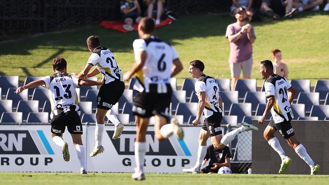 Bulls players celebrate Jake McGing’s match-winning goal. Picture: Mark Kolbe/Getty Images