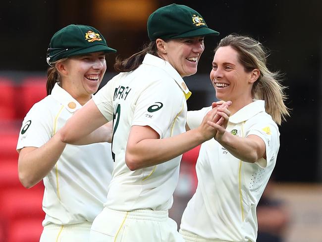 GOLD COAST, AUSTRALIA - SEPTEMBER 30: Sophie Molineux of Australia celebrates with team mates after dismissing Shafali Verma of India during day one of the Women's International Test match between Australia and India at Metricon Stadium on September 30, 2021 in Gold Coast, Australia. (Photo by Chris Hyde/Getty Images)