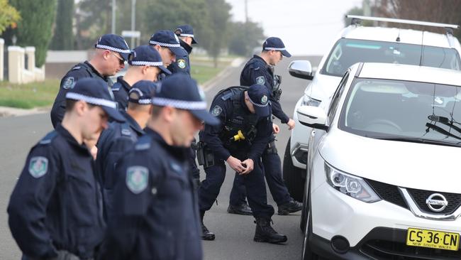 Police look under cars parked in Jones Street. Picture: Tim Hunter