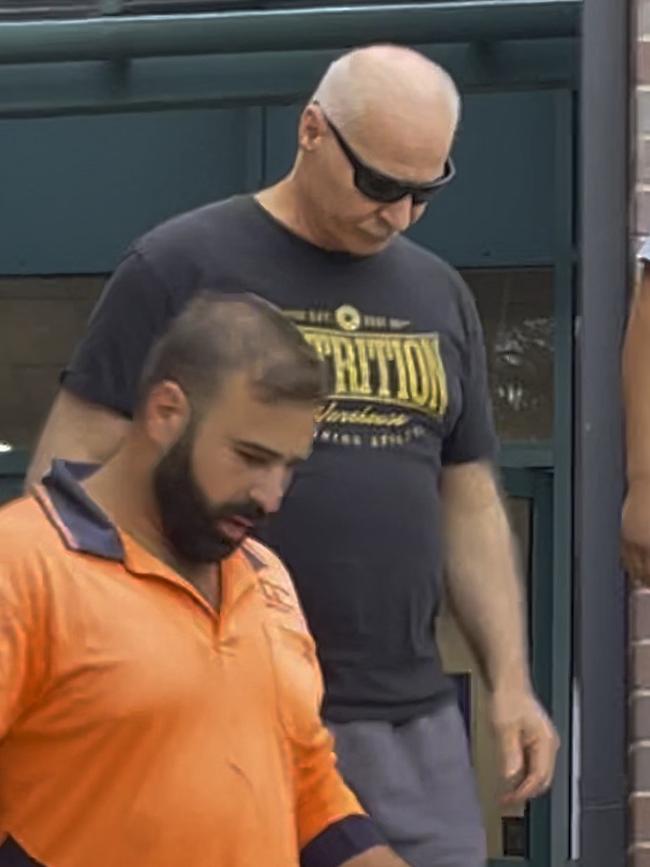 Joseph Geha (centre, sunglasses) leaving Hornsby Local Court on December 7, 2022 with his son. Geha has been charged with wounding with intent to cause grievous bodily harm after allegedly stabbing his neighbour with a steak knife. Picture: Odessa Blain