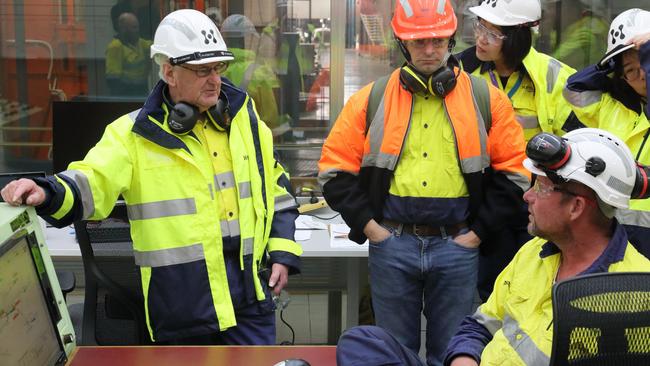 Engineer Mike Wallis who has clocked up 60 years with Hydro Tasmania and Entura, consults with the team. Picture: Colin Terry/ Hydro Tasmania