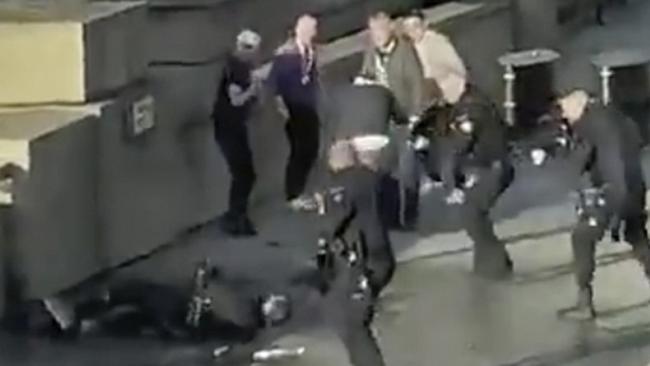 In this grab taken from video made available by @HLOBlog, a man is surrounded by police after an incident on London Bridge, in London, Friday, Nov. 29, 2019. A man wearing a fake explosive vest stabbed several people before being tackled by members of the public and then shot dead by armed officers on London Bridge, police and the cityÃ¢â‚¬â„¢s mayor say. Police say they are treating it as a terrorist attack. (@HLOBlog via AP)