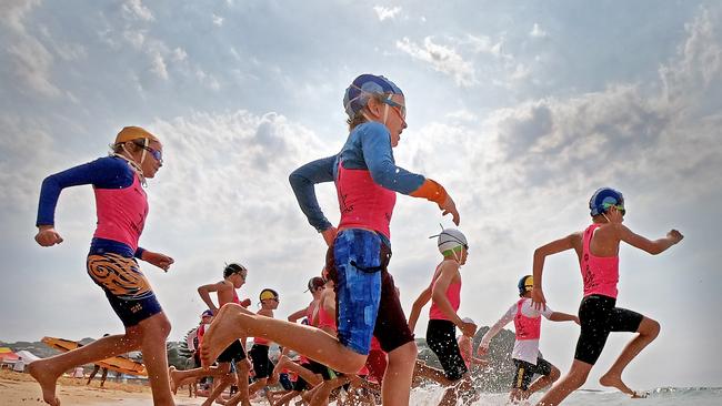 Competitors hit the water during the under-9 boys surf race at the Surf Life Saving Central Coast junior branch championships at Copacabana Beach. Picture: Troy Snook