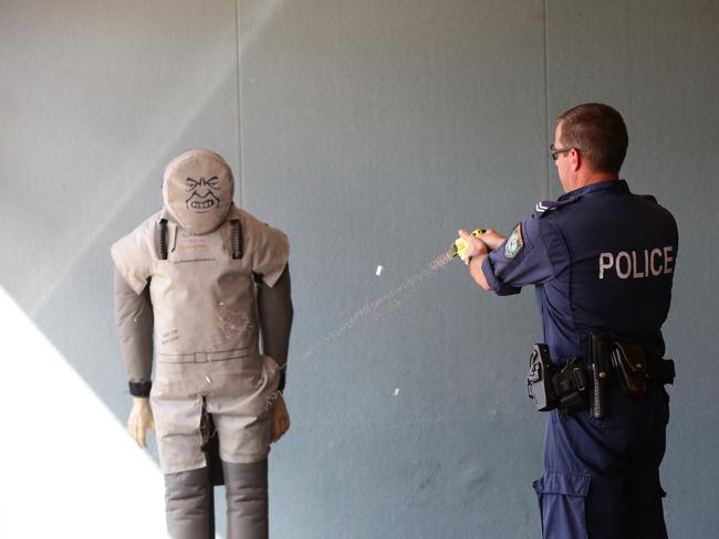 Snr Constable Brett Eadie demonstrates taser at Davistown RSL. Picture: Sue Graham