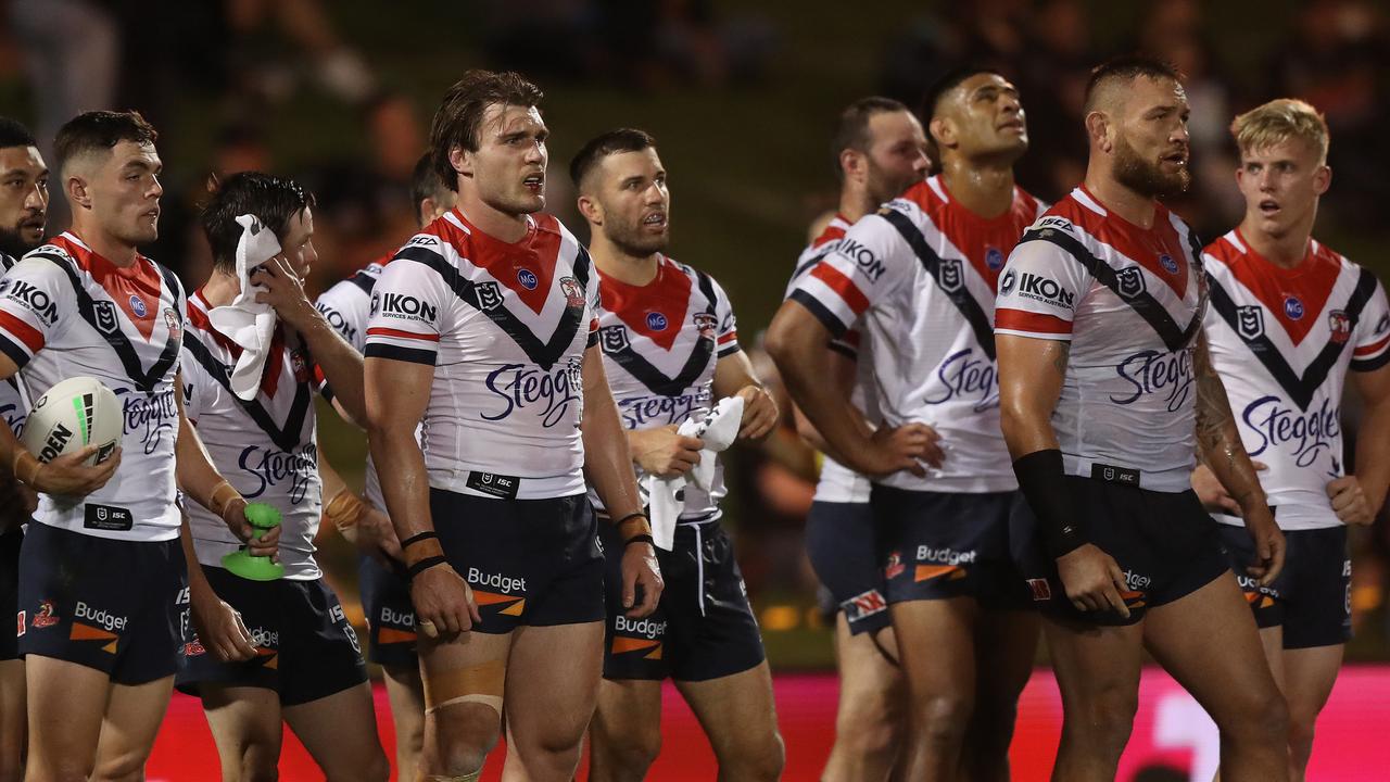 Dejected Roosters players look on after a Penrith try