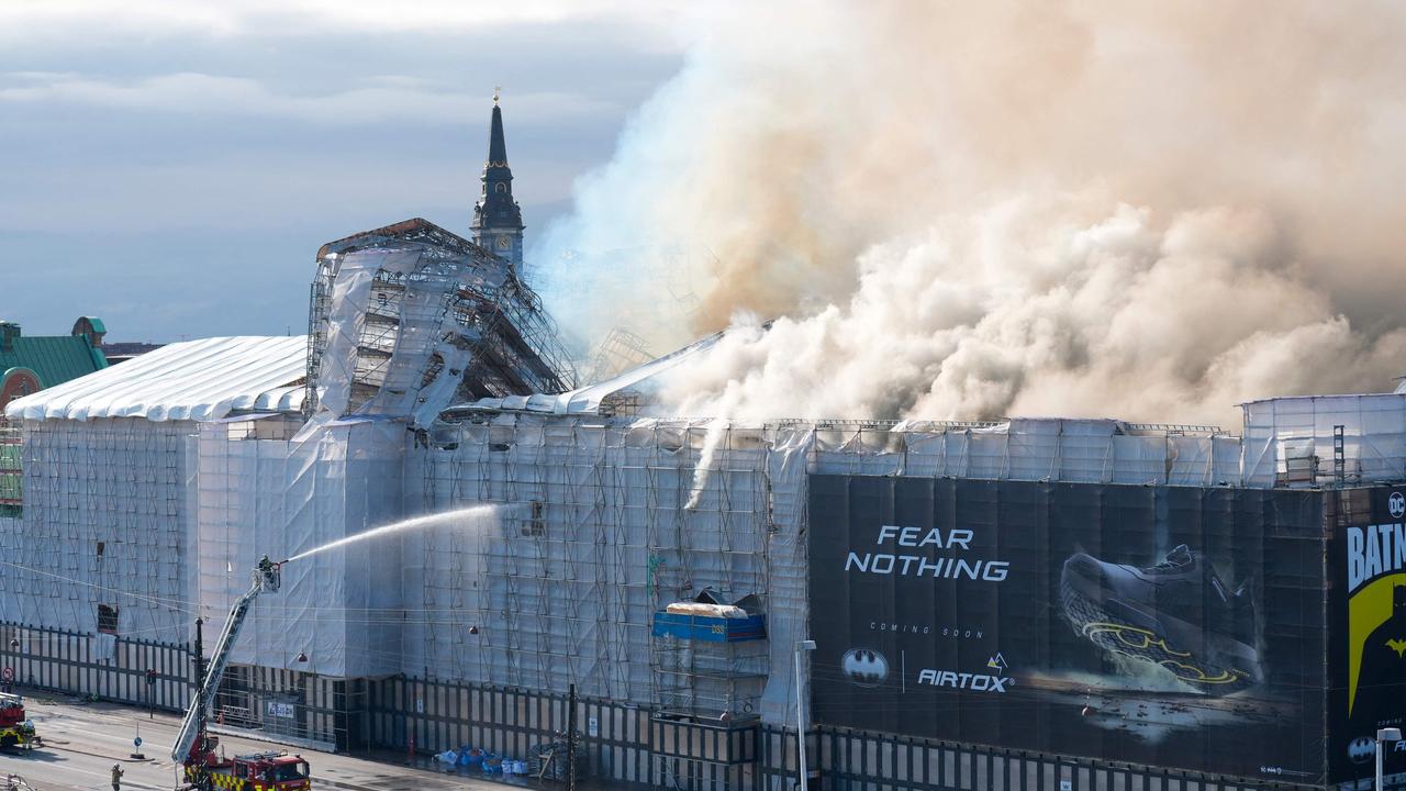 Plumes of smoke billow from the historic Borsen stock exchange building which is on fire in central Copenhagen. Picture: Ritzau Scanpix / AFP / Denmark OUT