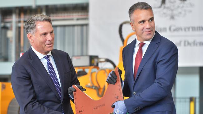 Defence Minister Richard Marles and Malinauskas hold a piece of steel to be used on the first Hunter class frigate to be constructed at the Osborne Naval Shipyard in Adelaide. Picture: NewsWire/Brenton Edwards