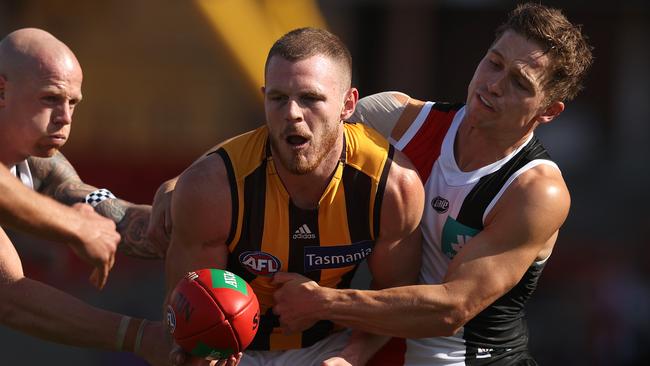 Hawk Blake Hardwick does his best to get a handball away. Picture: Chris Hyde/Getty Images