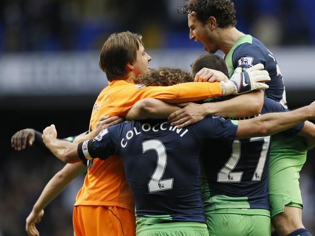 Newcastle's goalkeeper Tim Krul celebrates with Fabricio Coloccini and Daryl Janmaat, right, as his side win the English Premier League soccer match between Tottenham Hotspur and Newcastle United at White Hart Lane stadium in London, Sunday, Oct. 26, 2014. (AP Photo/Kirsty Wigglesworth)