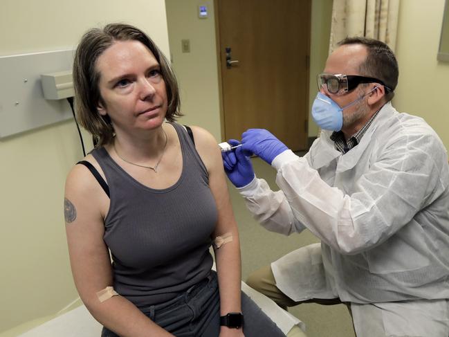 A pharmacist giving Jennifer Haller (left) a shot in the first stage of a safety study clinical trial of a potential vaccine for COVID-19 at the Kaiser Permanente Washington Health Research Institute in Seattle. Picture: Ted S. Warren